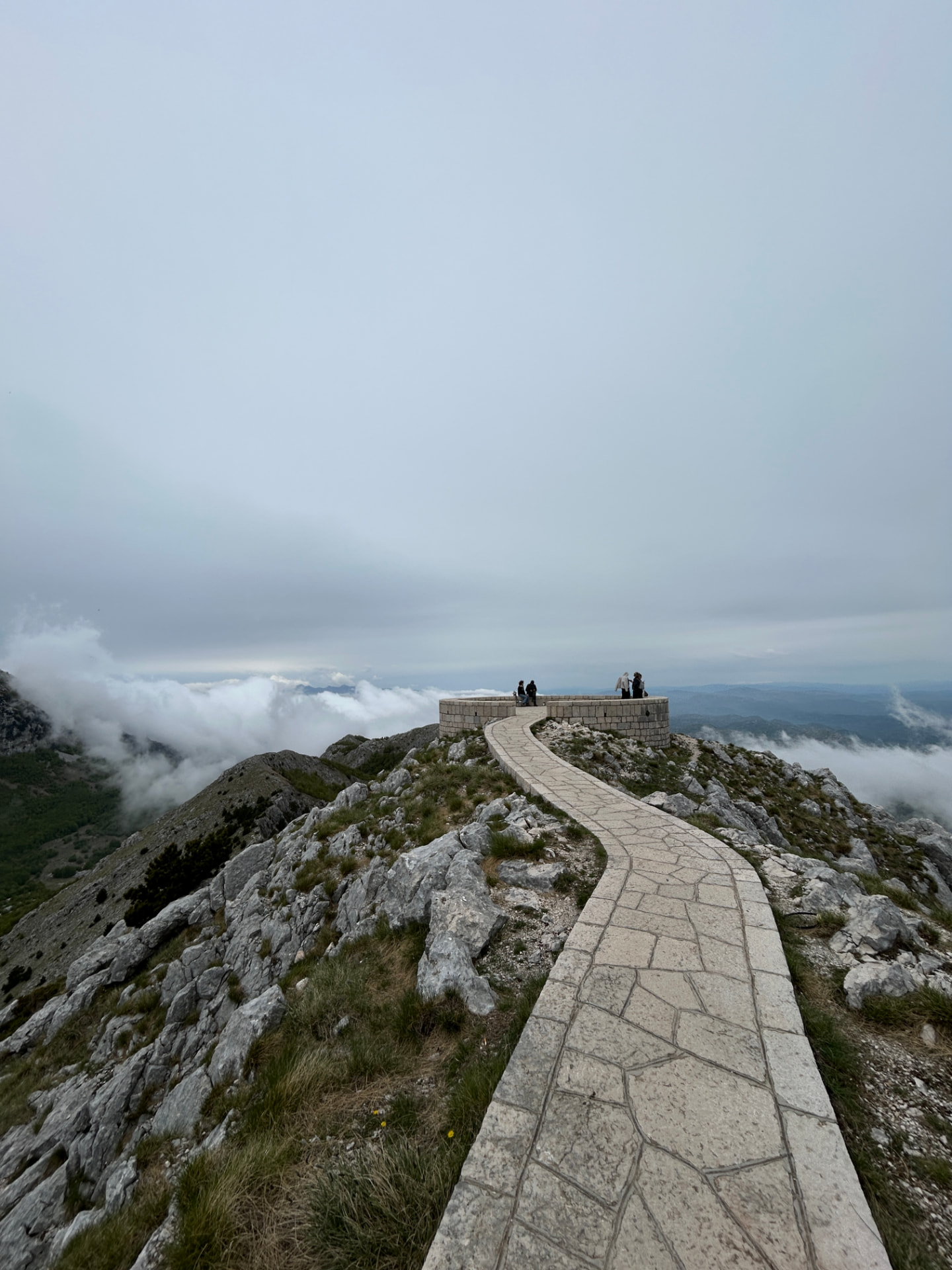 Winding stone path to the Lovćen mausoleum viewpoint above the clouds